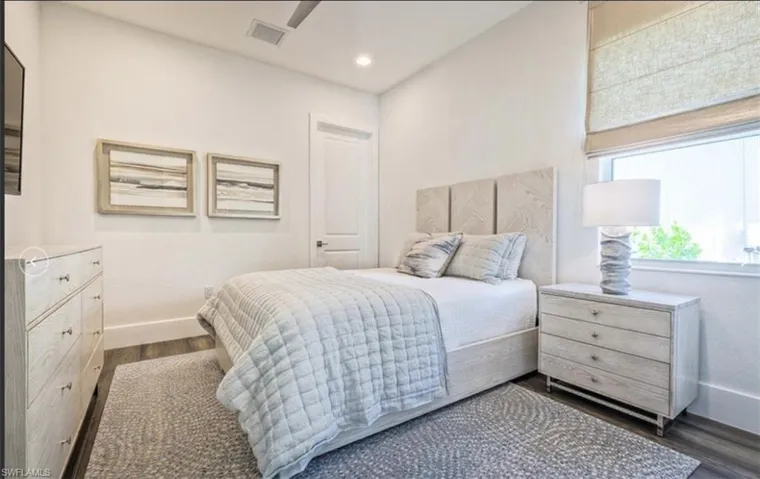 Bedroom with baseboards and dark wood finished floors