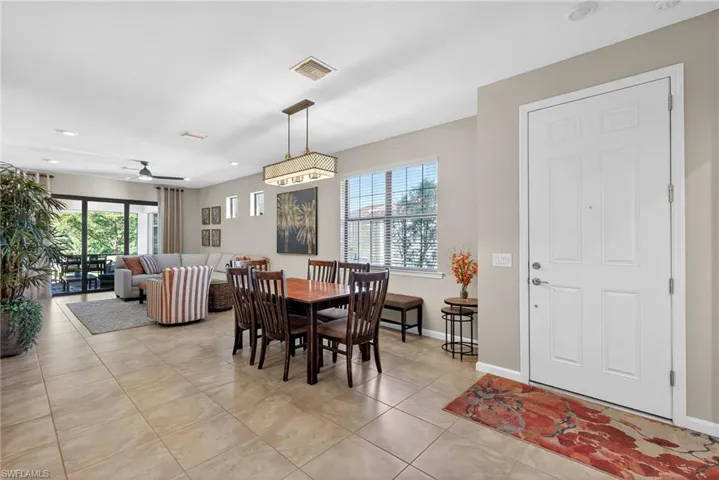 Dining space with light tile patterned flooring, healthy amount of natural light, ceiling fan, and recessed lighting