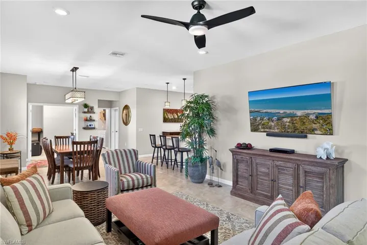 Living area with recessed lighting and a ceiling fan