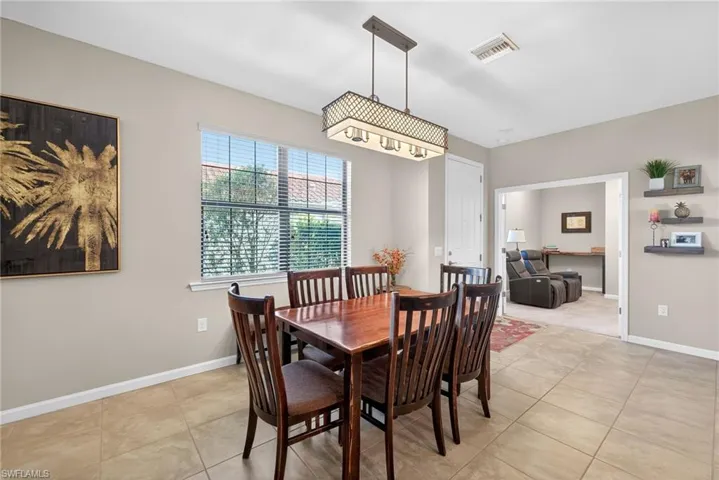 Dining space featuring light tile patterned floors and baseboards