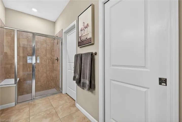Bathroom featuring a stall shower and light tile patterned floors