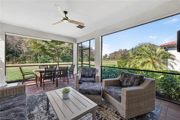 Sunroom featuring brick floors, outdoor lounge area, a ceiling fan, and outdoor dining space