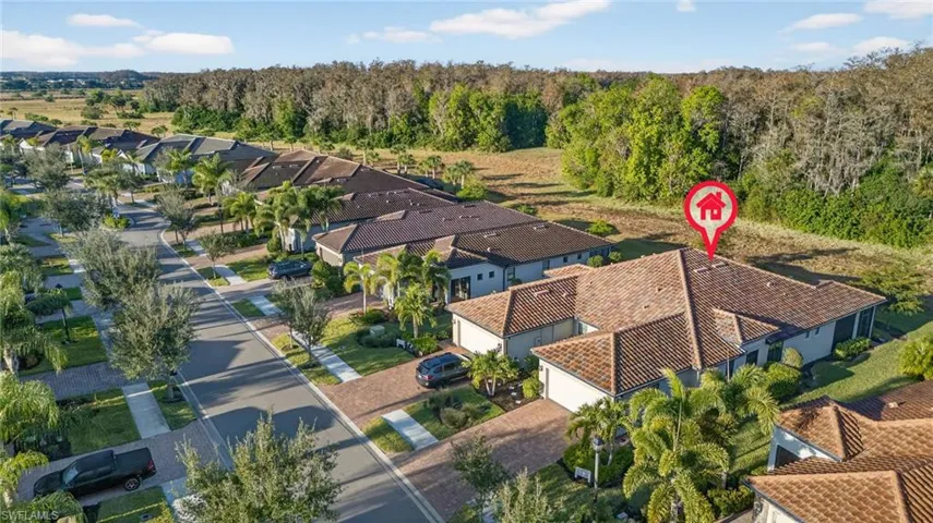 Aerial view of property and surrounding area featuring nearby suburban area