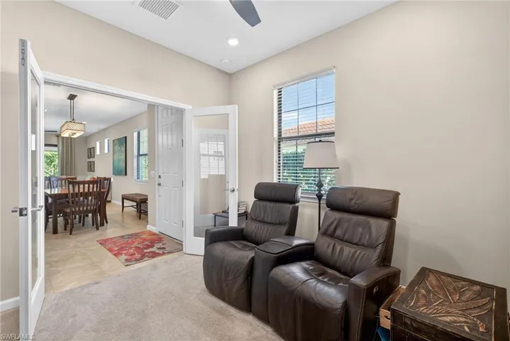 Living area featuring french doors, carpet, tile patterned floors, recessed lighting, and a ceiling fan