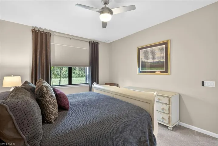 Bedroom featuring a ceiling fan and carpet floors