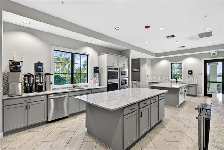 Kitchen featuring gray cabinets, light stone countertops, appliances with stainless steel finishes, recessed lighting, and wood tiled floors