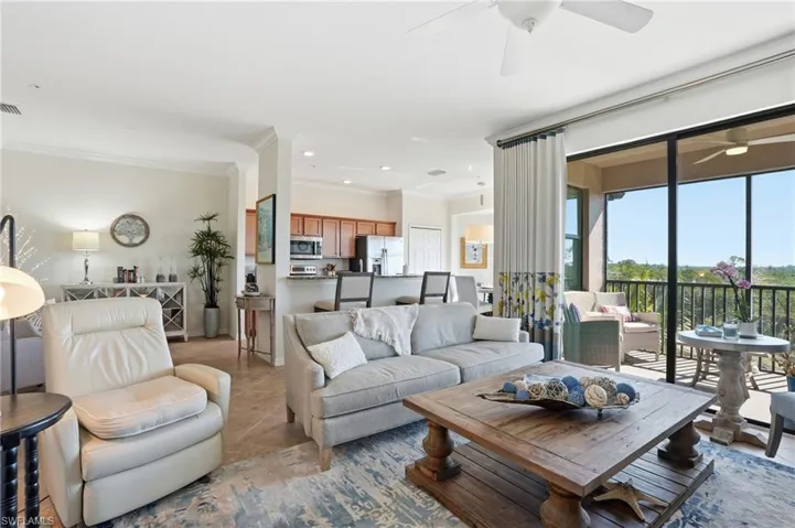 Living area featuring ornamental molding, light tile patterned floors, recessed lighting, and ceiling fan