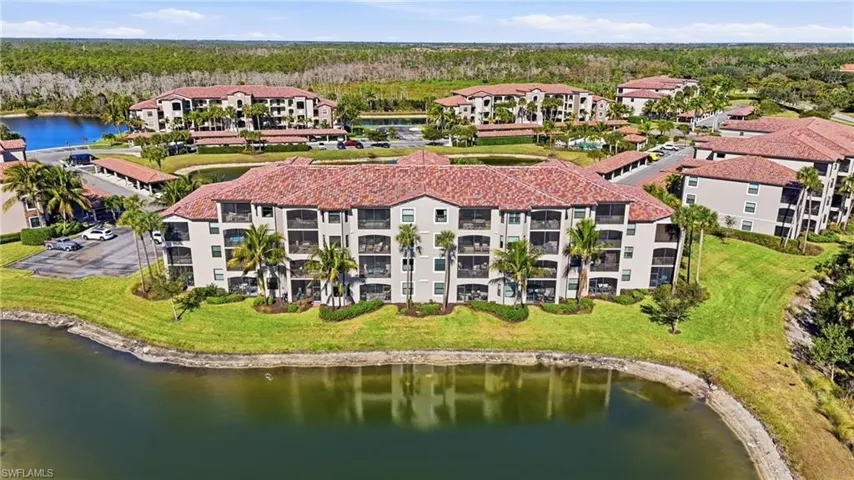 Drone / aerial view of a large body of water and apartment complex