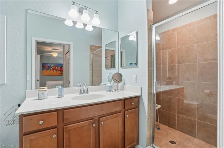 Bathroom with vanity, a stall shower, and ensuite bathroom