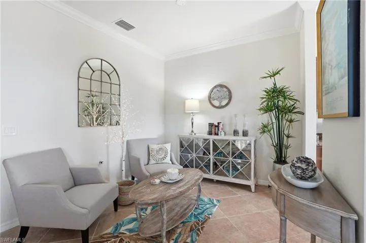 Sitting room featuring ornamental molding and tile patterned floors