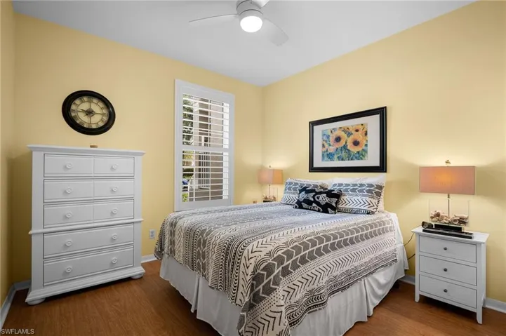 Bedroom with dark wood-style floors and ceiling fan