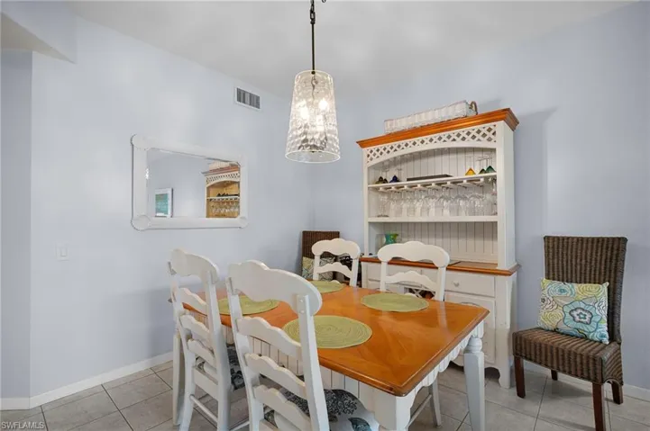 Dining space featuring a chandelier and light tile patterned floors