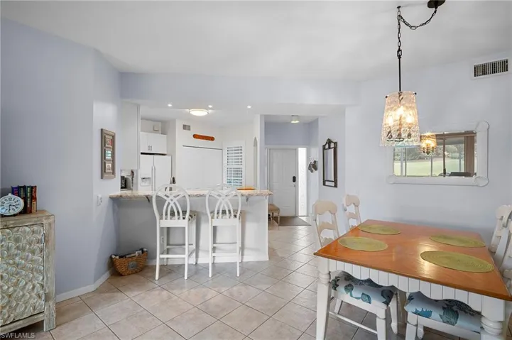 Dining room featuring light tile patterned floors and a chandelier