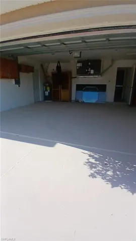 Garage featuring electric water heater