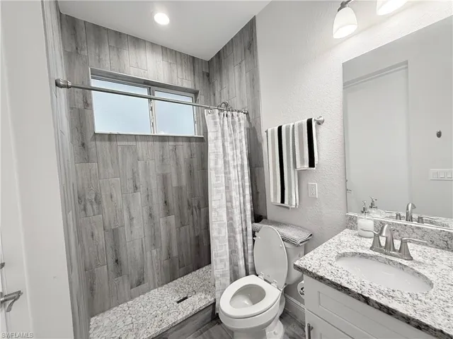 Bedroom featuring wood finished floors and ceiling fan