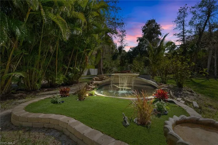 Dusk Conversion View of home's community with a lawn