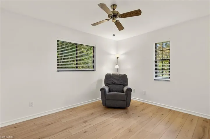 Living area featuring ceiling fan and light hardwood / wood-style floors
