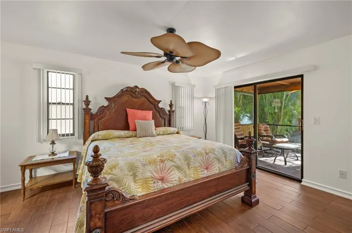 Bedroom with access to outside, ceiling fan, and hardwood / wood-style floors
