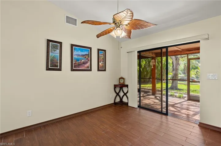 Empty room featuring ceiling fan, vaulted ceiling, and hardwood / wood-style flooring