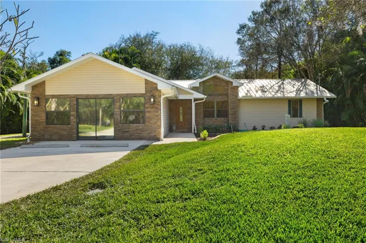 Single story home with a front lawn