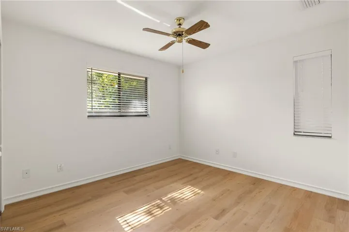 Unfurnished room with ceiling fan and light wood-type flooring