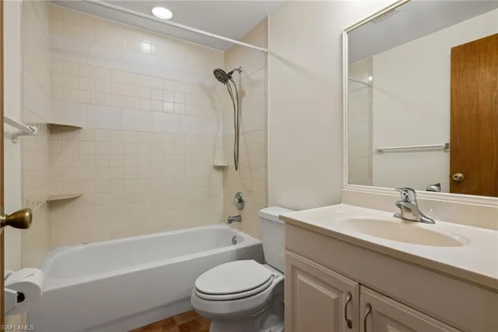 Full bathroom featuring tile patterned flooring, vanity,  shower combination, and toilet
