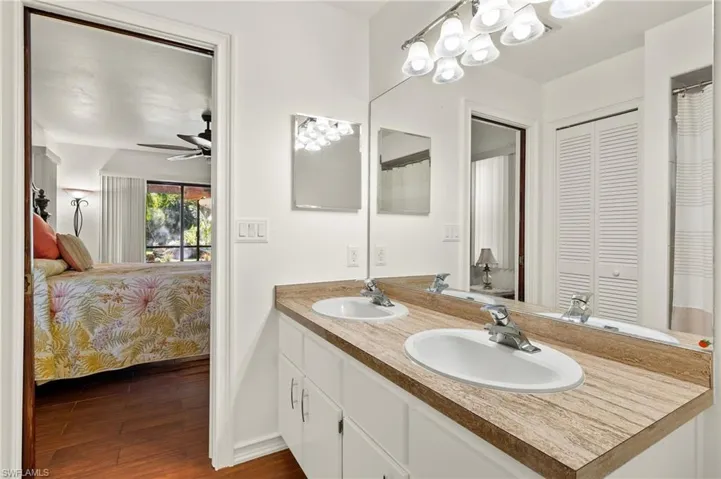 Bathroom with ceiling fan, vanity, and hardwood / wood-style flooring