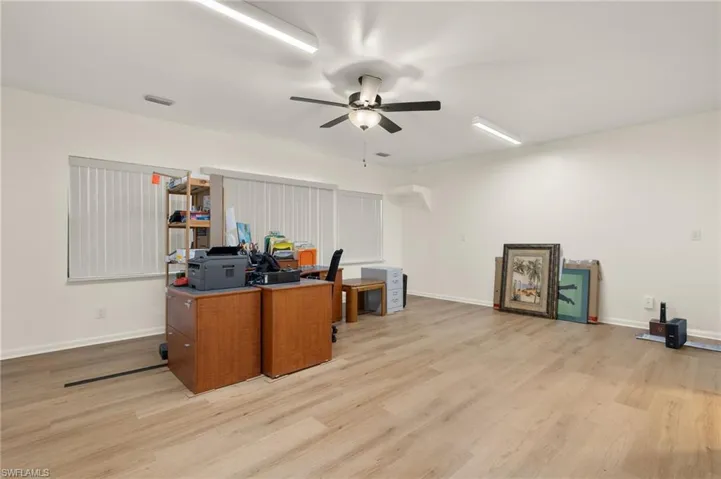 Office area with light hardwood / wood-style flooring and ceiling fan