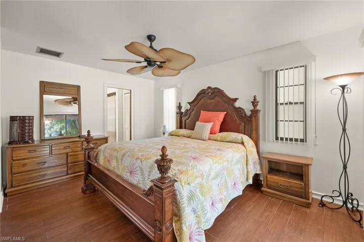 Bedroom featuring ceiling fan and dark hardwood / wood-style flooring
