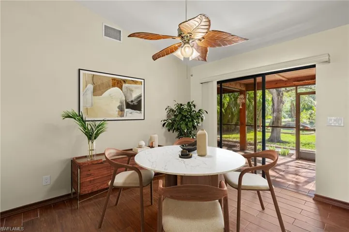 Virtual Staging Dining area with ceiling fan, dark hardwood / wood-style flooring, and lofted ceiling