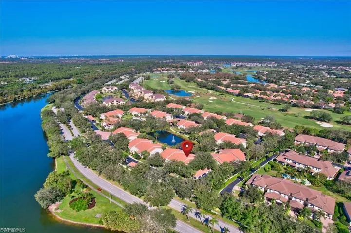 Aerial view of property's location with a nearby body of water and nearby suburban area