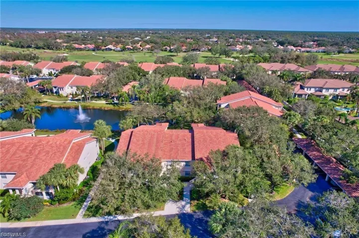 Aerial perspective of suburban area featuring a large body of water