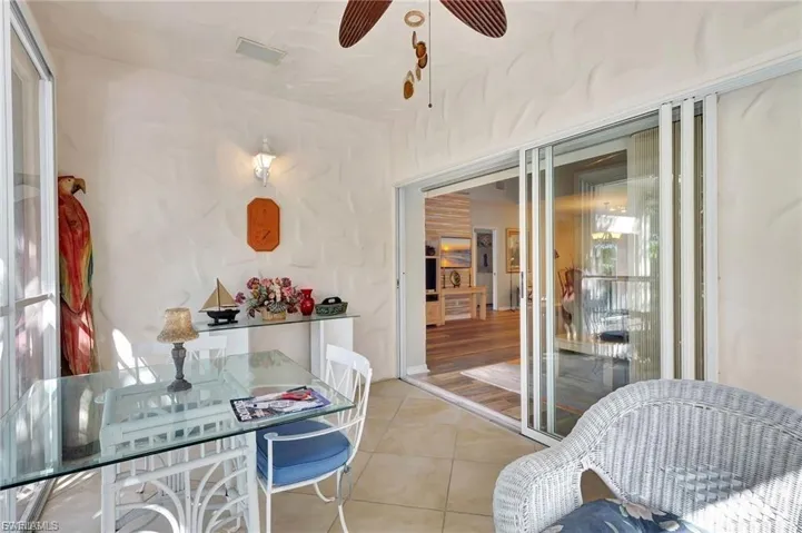 Dining room with a ceiling fan and light tile patterned floors
