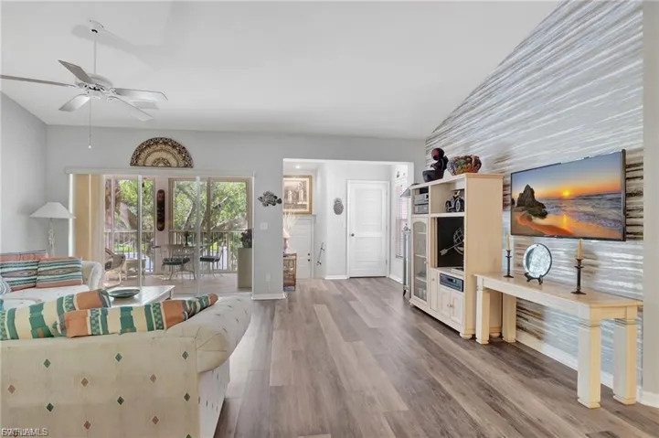 Living area with french doors, wood finished floors, and a ceiling fan