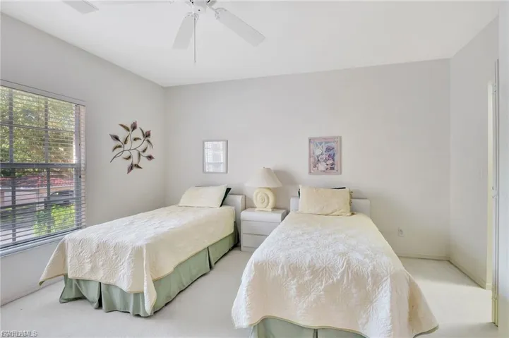 Bedroom with light carpet and ceiling fan
