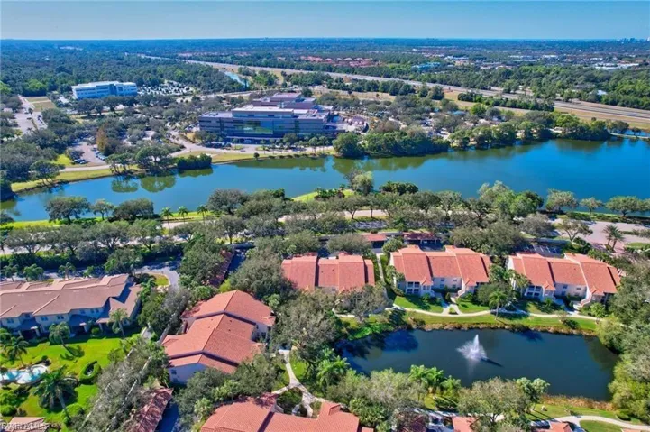 Aerial perspective of suburban area featuring a large body of water