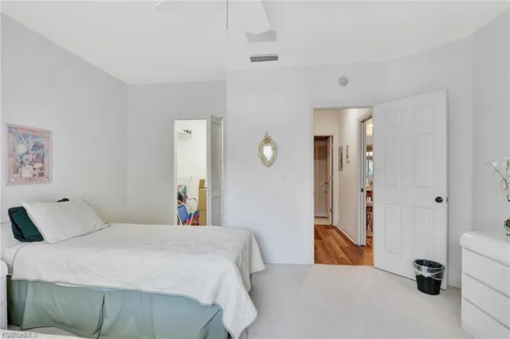 Carpeted bedroom featuring ceiling fan and baseboards