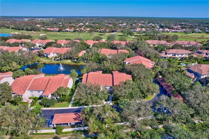 Aerial view of residential area featuring a nearby body of water