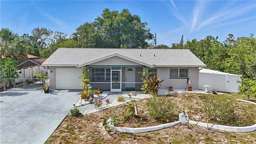 Ranch-style home with stucco siding, driveway, a gate, and a shingled roof