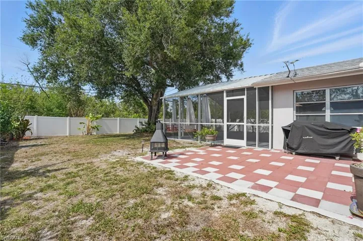 Fenced backyard with a patio area and a sunroom