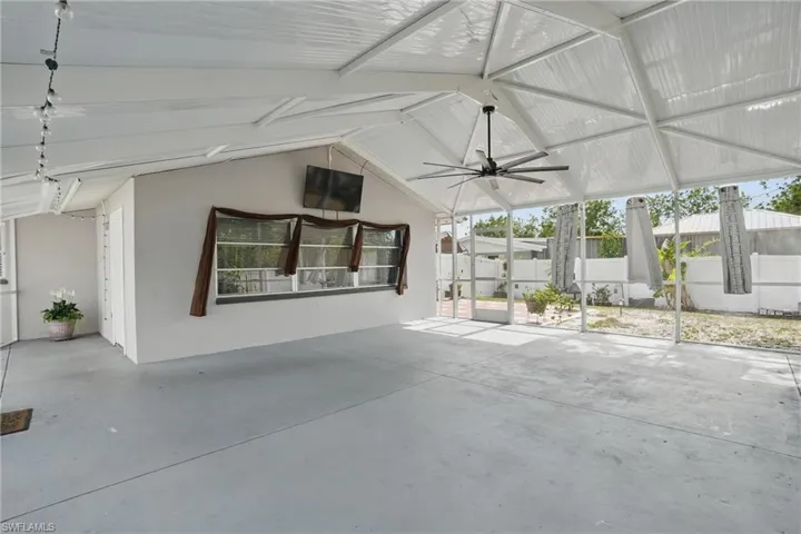 View of patio / terrace with a ceiling fan and a sunroom