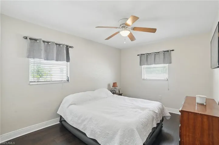 Bedroom featuring dark wood finished floors and ceiling fan
