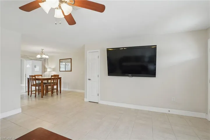 Living room with ceiling fan and a chandelier