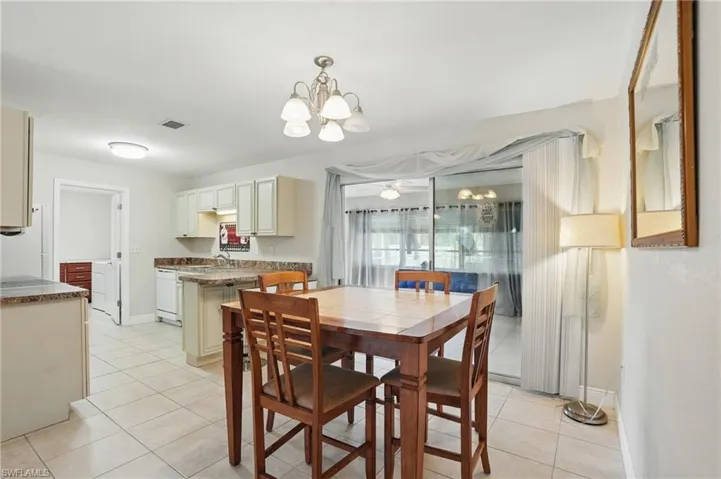 Dining area featuring a chandelier and light tile patterned floors