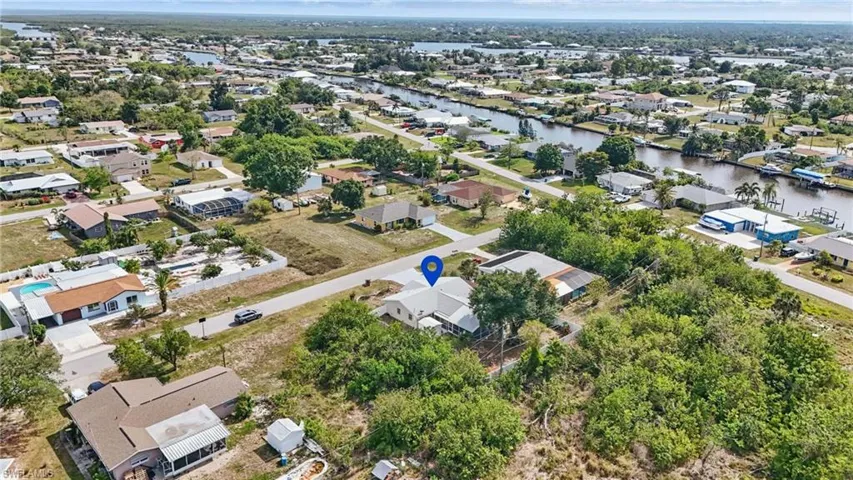Aerial view of property's location with nearby suburban area and a large body of water