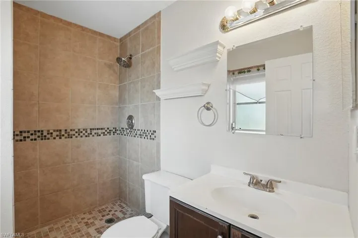 Bathroom featuring vanity and a shower stall