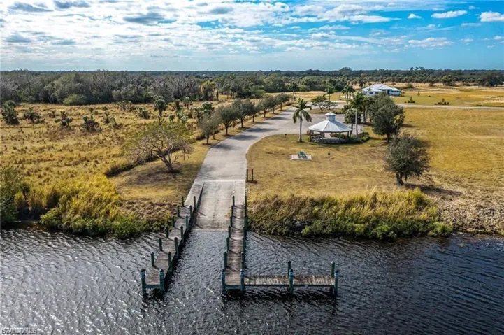 Overview of rural landscape featuring a nearby body of water and a tree filled landscape