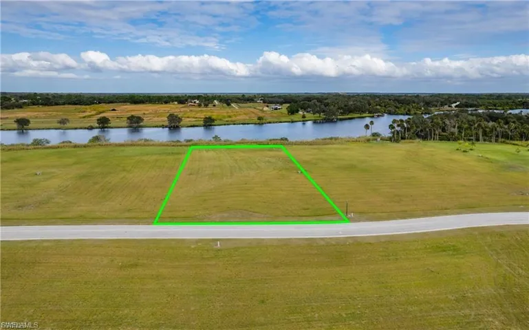Overview of rural landscape featuring property boundaries highlighted and a nearby body of water