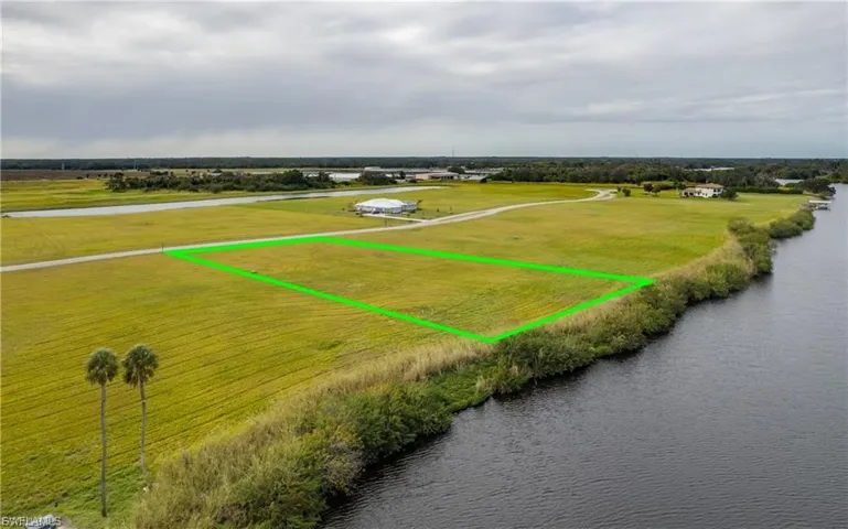 Overview of rural landscape featuring a large body of water and property boundaries highlighted
