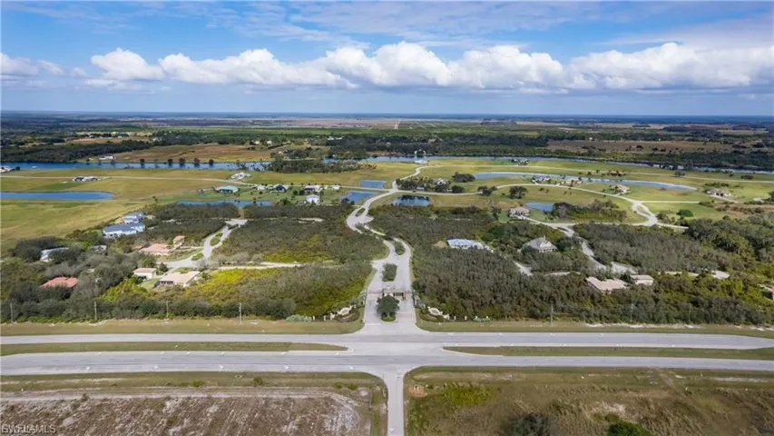 Aerial view of property's location featuring a large body of water